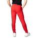 Bright red Tommy Hilfiger joggers with elastic cuffs paired with white sneakers