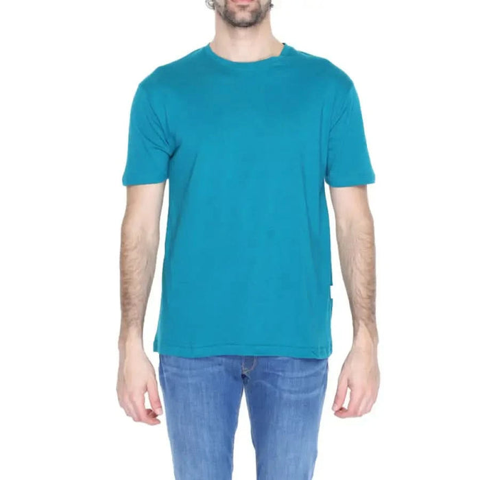 Gianni Lupo Men T-Shirt in bright teal paired with blue jeans displayed on a model