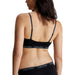 Calvin Klein black sports bra and underwear set on a woman, rear view