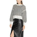 Chevron-patterned sweater with white collar and cuffs paired with black leather skirt