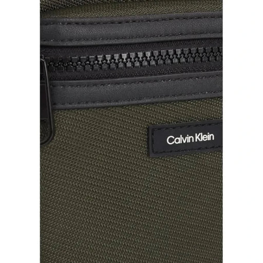 Close-up of a Calvin Klein Men Bag showcasing olive green and black materials with zipper