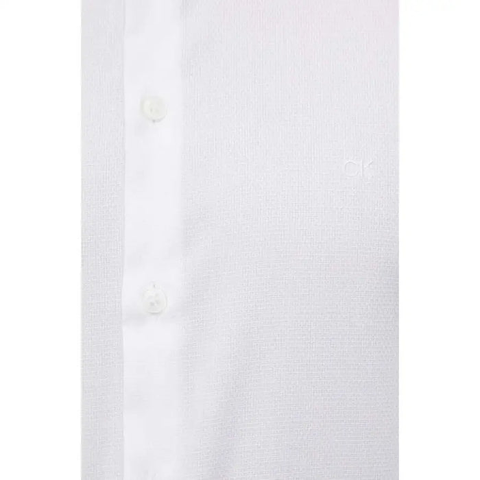 Close-up view of white button-up shirt fabric from Calvin Klein Men Shirt collection