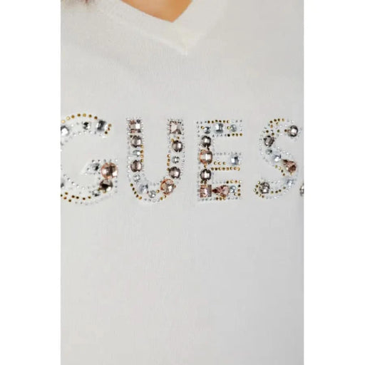 Close-up of Guess women knitwear, white sweater with Guess logo