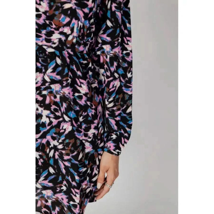 Colorful patterned dress with long sleeves featuring pink, blue, and black abstract floral design