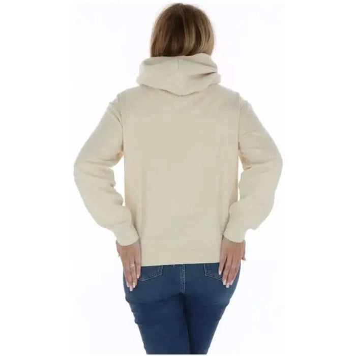 Champion Women Sweatshirts - Person wearing a cream-colored hoodie, back view