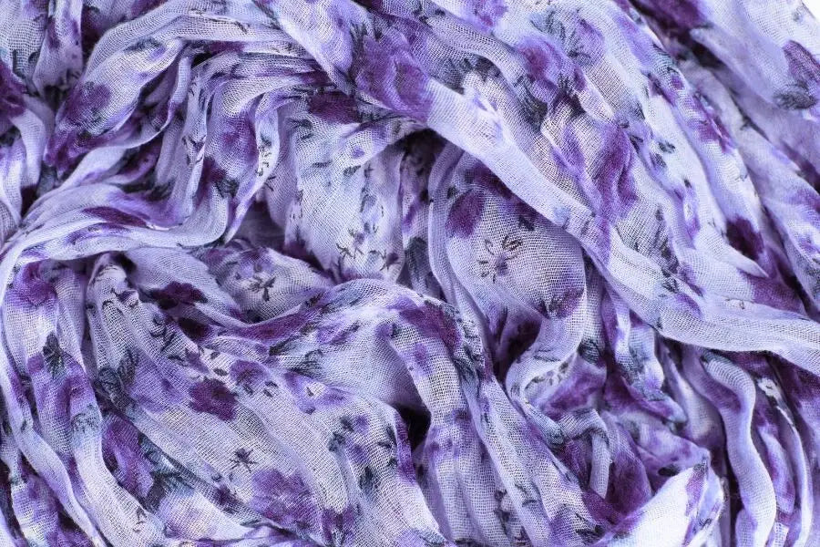 Crumpled purple and white marbled fabric, ideal as the best fabric for summer weather.