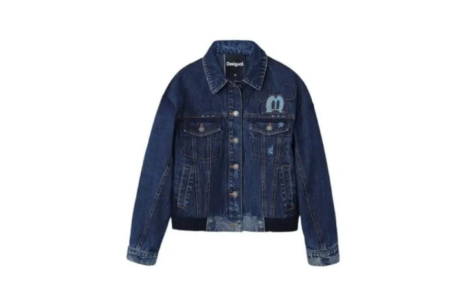 Dark blue denim jacket with button front and chest pockets for retro fashion style.