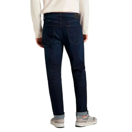 Dark blue denim jeans from the back featuring Lee Men Jeans design