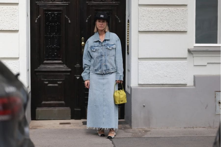 Double denim outfit featuring a light-wash jean jacket and matching maxi skirt.