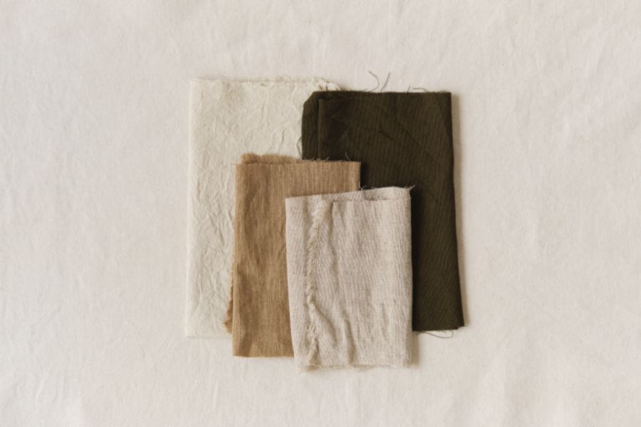 Fabric swatches in neutral tones showcasing the best fabric for summer weather.