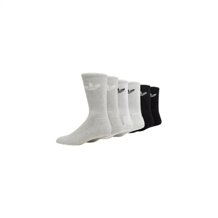 Five pairs of Nike athletic socks in white and black colors displayed with Adidas underwear