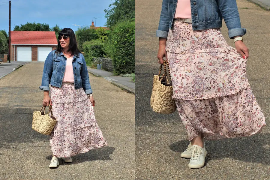 Floral tiered maxi skirt in pink and brown tones styled with a denim jacket.