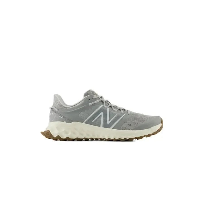 Gray New Balance running shoe featuring a white sole and gum rubber outsole