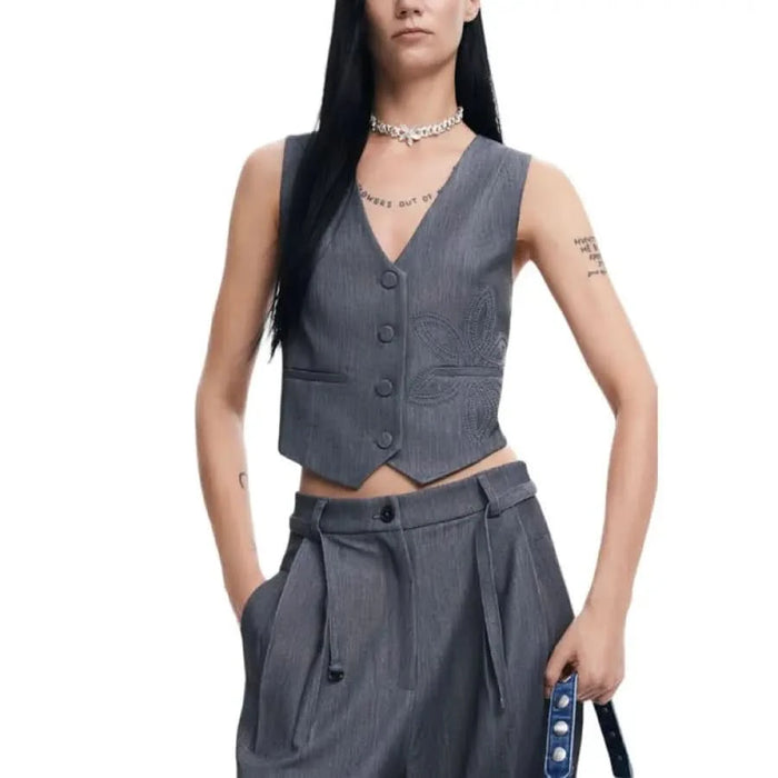 Gray pinstriped vest paired with matching high-waisted trousers by Desigual