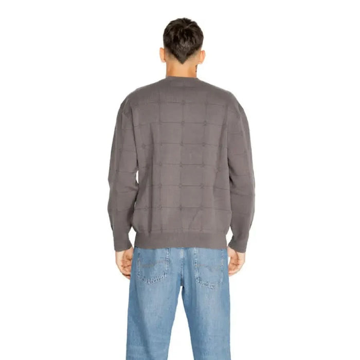 Gray sweater worn by a person seen from behind in Armani Exchange Men Knitwear