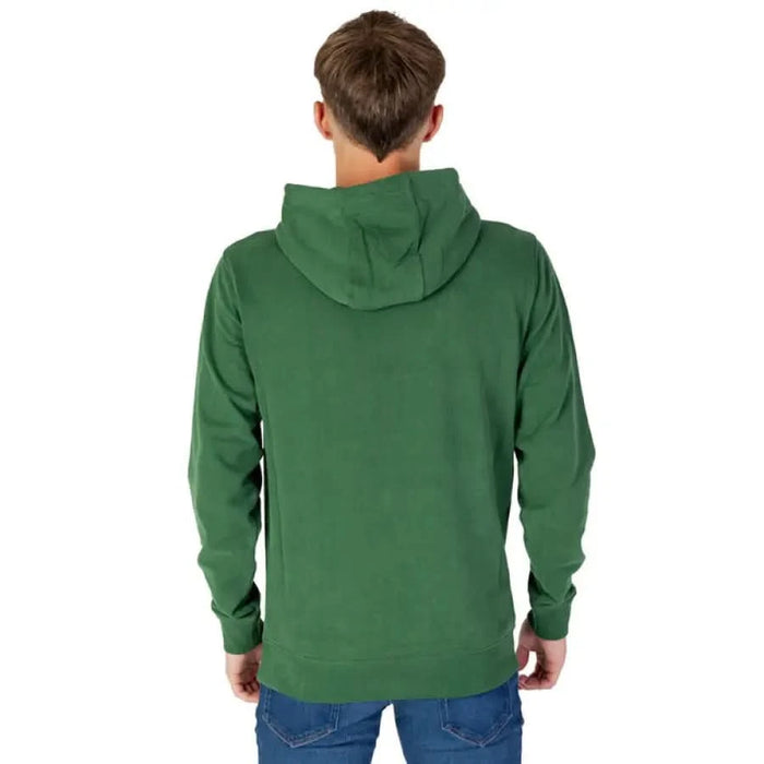 Rear view of person wearing green hooded sweatshirt from Tommy Hilfiger Jeans Men Sweatshirts