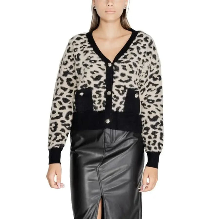 Leopard-print Morgan De Toi cardigan with black trim over a leather skirt