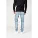 Light blue denim jeans worn with a black long-sleeved top by Calvin Klein Jeans