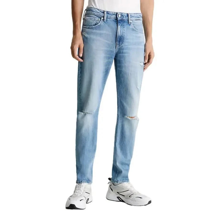 Light blue distressed Calvin Klein Jeans for men featuring rips at the knees