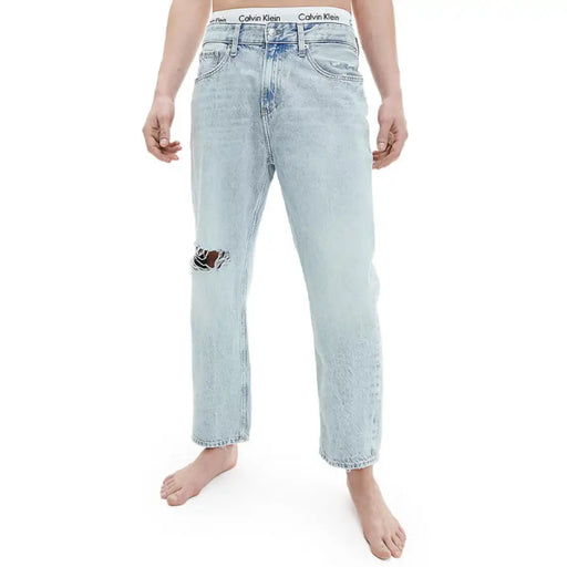 Light blue distressed jeans featuring a Calvin Klein waistband for men