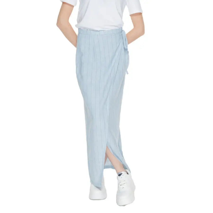 Vero Moda light blue maxi skirt with side slit paired with white sneakers