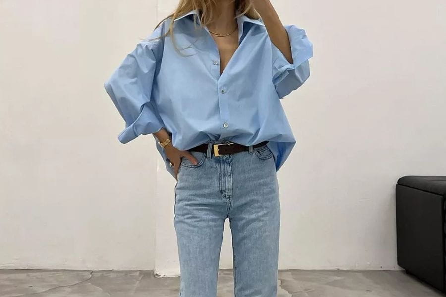 Light blue oversized shirt styled with light wash jeans for a trendy outfit idea.