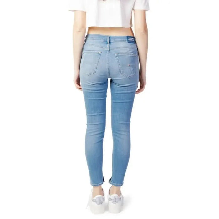 Light blue skinny Tommy Hilfiger jeans worn by a woman from the waist down