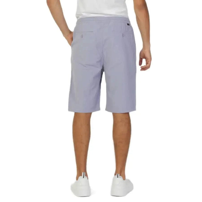 Light gray knee-length Lee Men Shorts worn by a person, from the Lee product line