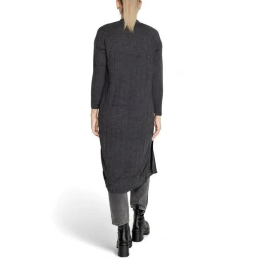 Long charcoal gray sweater dress with side slits styled over pants from Only Women