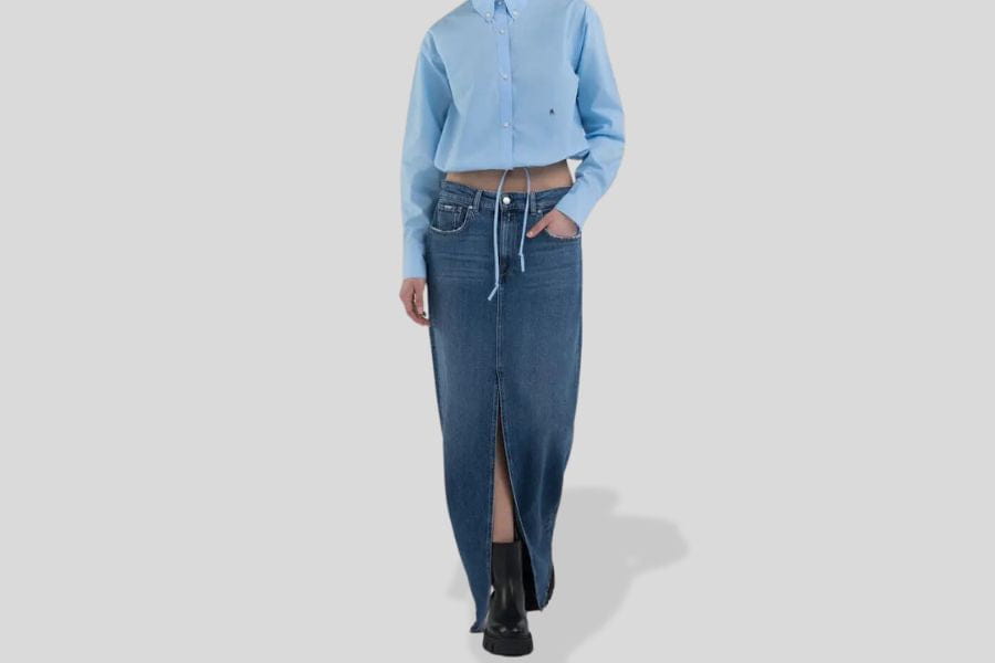 Long denim skirt featuring a front slit and drawstring waist style for trendy outfits.