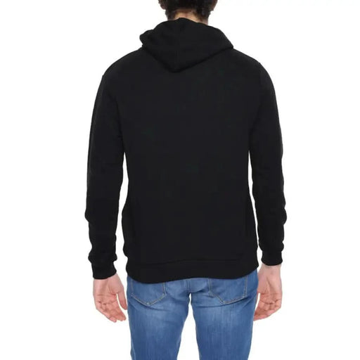 Man in black Icon sweatshirt showcasing urban city style fashion