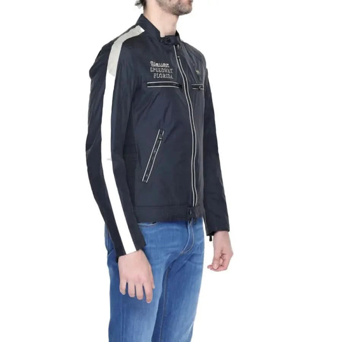 Man in Blauer urban style clothing, black jacket with white logo, for city fashion