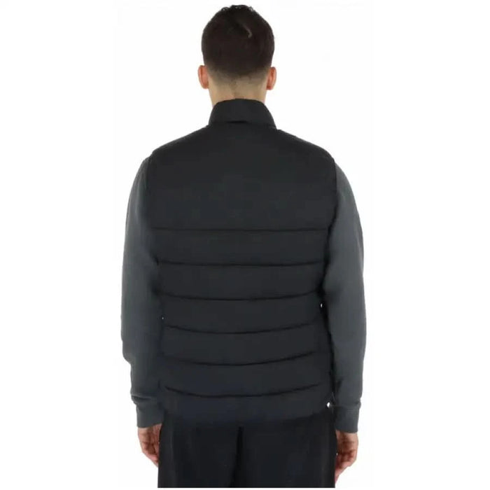 Lyle & Scott men gilet model in black jacket and pants on white background