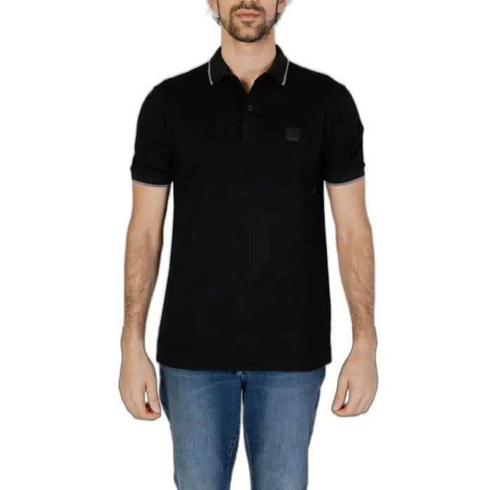 Man in Boss black polo shirt showcasing urban city style fashion