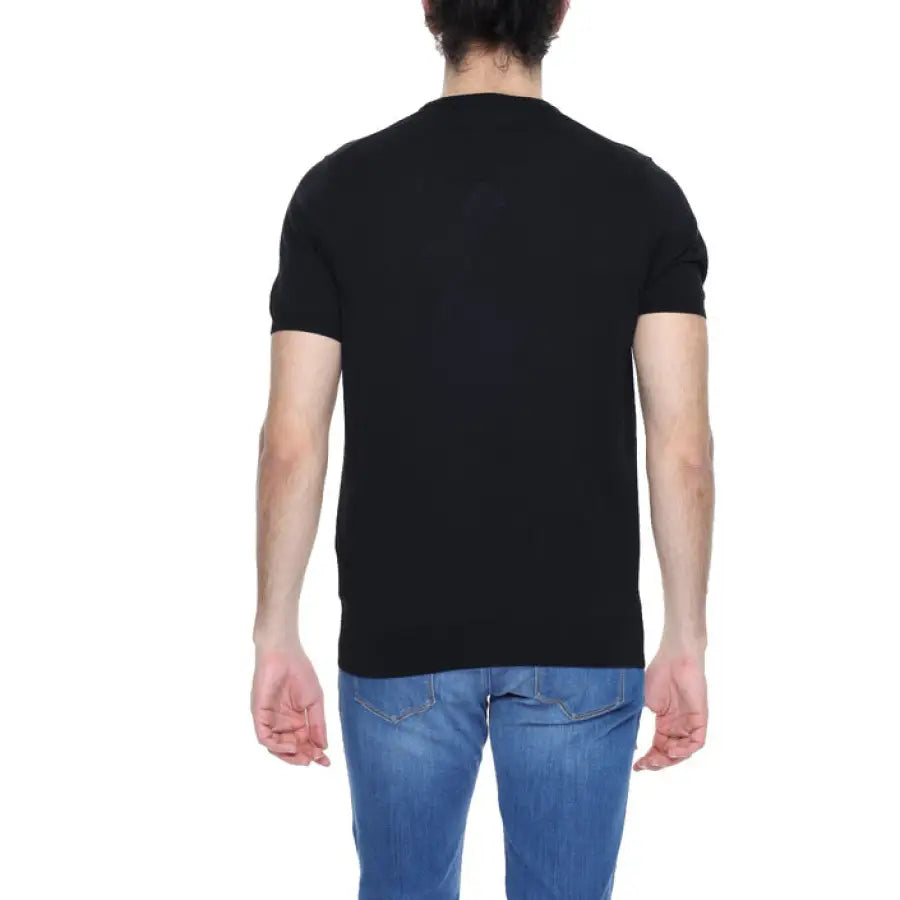 Man wearing a black polo shirt from Diktat Men Knitwear collection