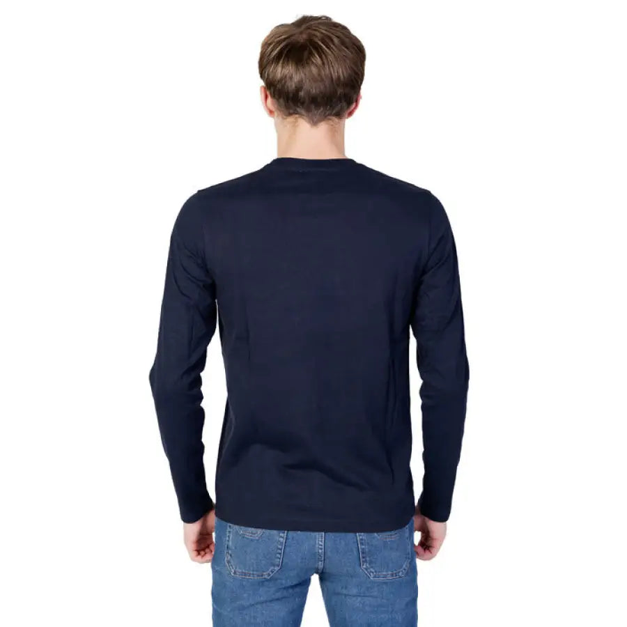 Man wearing U.S. Polo Assn. black shirt and jeans from the Men Knitwear collection