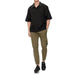 Man in Calvin Klein black short-sleeved shirt, olive cargo pants, and black sneakers