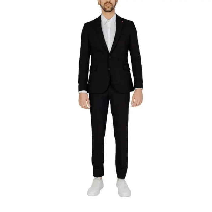 Man in black suit and white shoes showcasing urban city style from Mulish Men Suit collection