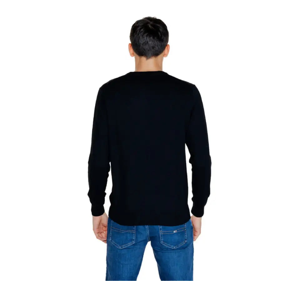 Man in black sweater and jeans from Guess Men Knitwear collection