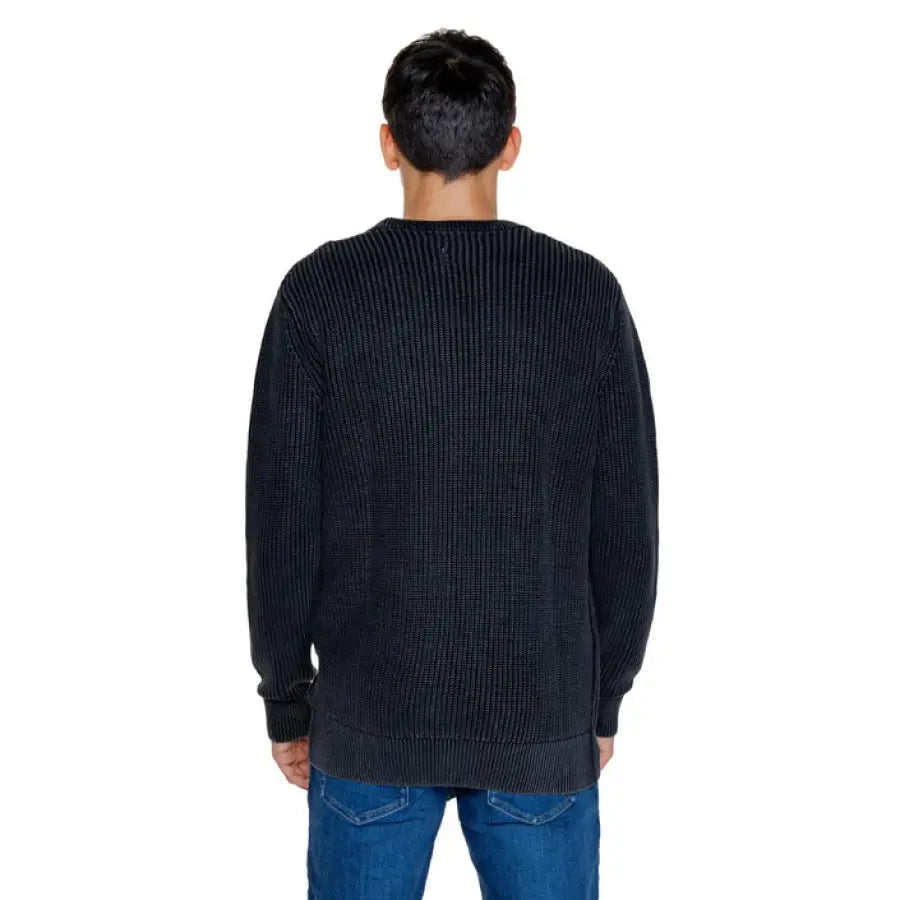 Man wearing black sweater and jeans from Guess - Guess Men Knitwear collection
