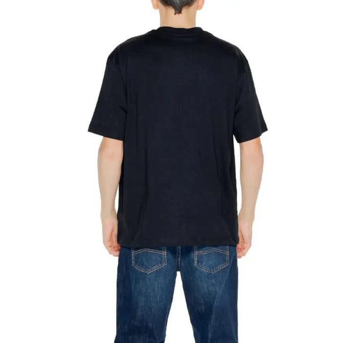 Urban style: Man in black T-shirt and jeans from Pharmacy Men T-Shirt collection