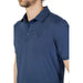 Man in blue polo shirt embodying urban city style for Blauer Men Polo clothing