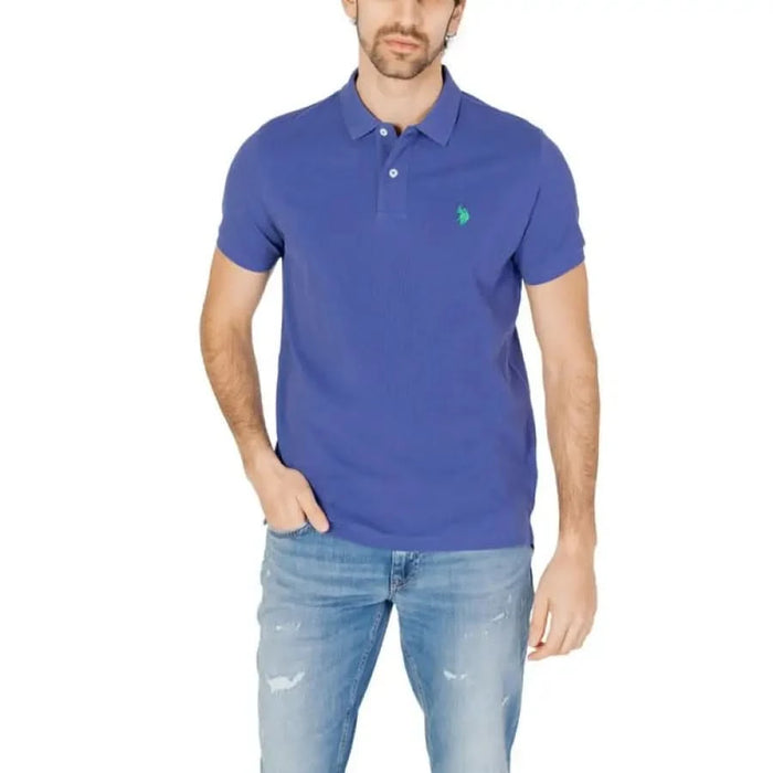 A man wearing a blue polo shirt and jeans from U.s. Polo Assn. Men Polo collection