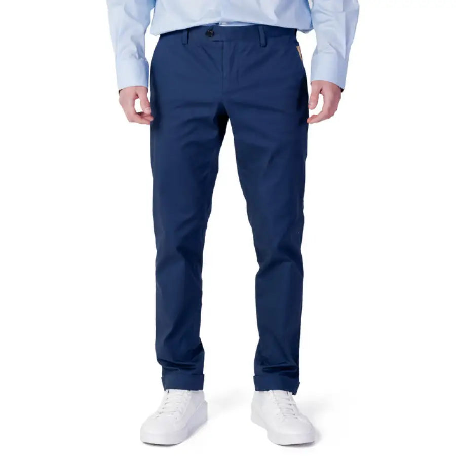 
                      
                        Man wearing blue shirt and Alviero Martini Prima Classe trousers for stylish menswear
                      
                    