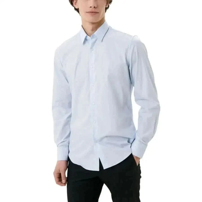 Antony Morato men shirt for fall winter, man in blue shirt and black pants.