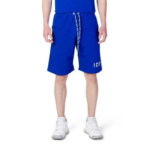 Man in Icon-Icon Men Shorts showcasing urban city style with blue shorts and white T-shirt