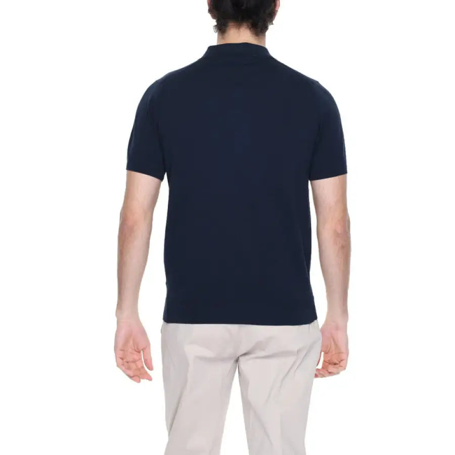 A man in a navy polo shirt from the Diktat Men Knitwear collection