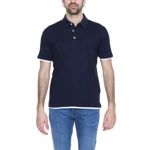 A man wearing a navy Hamaki-ho Men Polo shirt from the Hamaki-ho collection