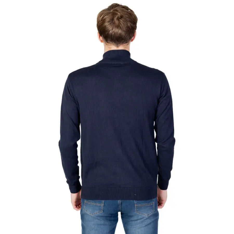 Man wearing a navy sweater jacket from the U.S. Polo Assn. Men Knitwear collection