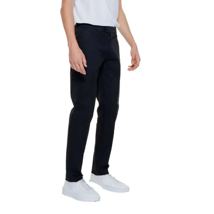 A man in a white shirt and black Antony Morato Men Trousers, perfect for an urban look